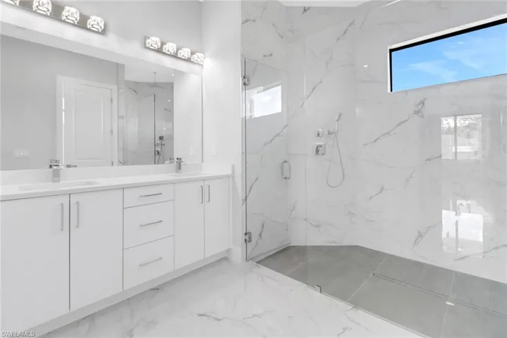 Bathroom with vanity and a shower with shower door