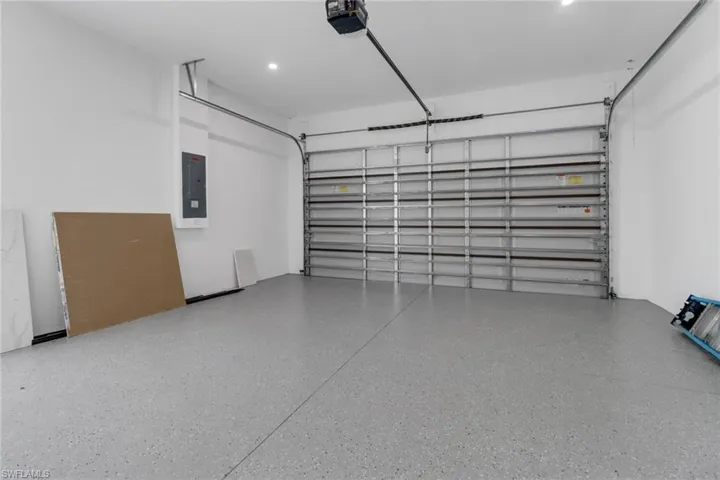 Garage with a garage door opener and electric panel