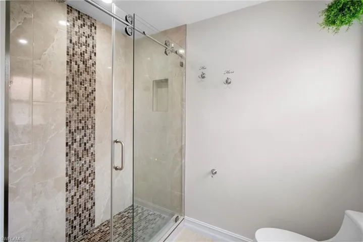 Bathroom with a stall shower and toilet