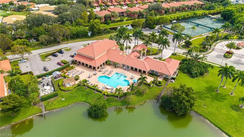 Aerial view of a pool area and a large body of water