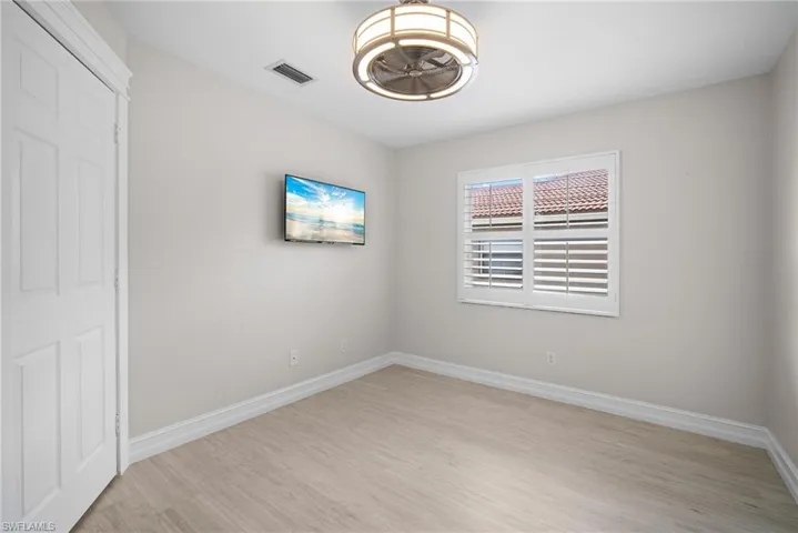 Unfurnished bedroom with light wood-style floors and a closet