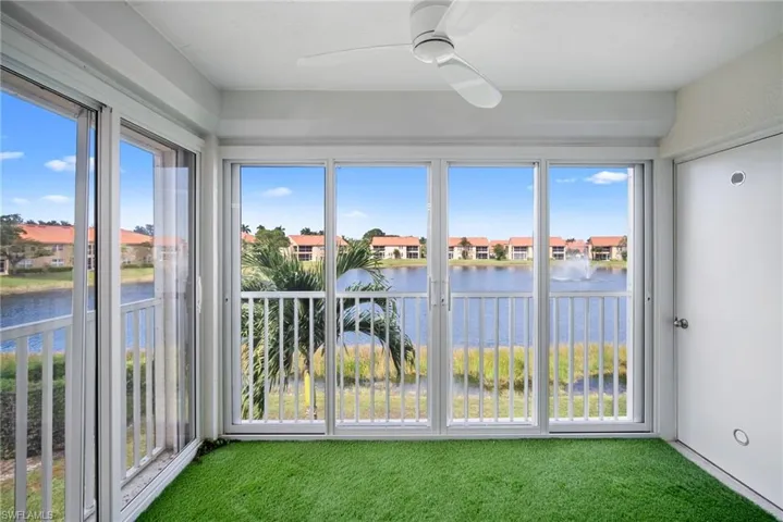 Unfurnished sunroom featuring a water view and carpet floors