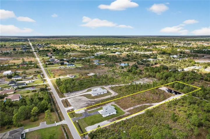 Aerial view of residential area with property parcel outlined