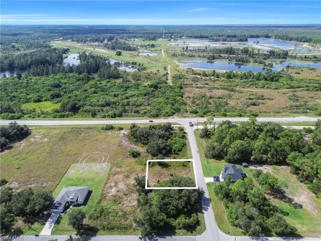 Aerial view of property's location with a large body of water and property parcel outlined