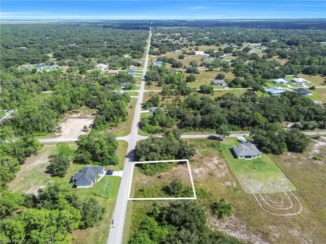 Aerial overview of property's location featuring property boundaries highlighted and a heavily wooded area