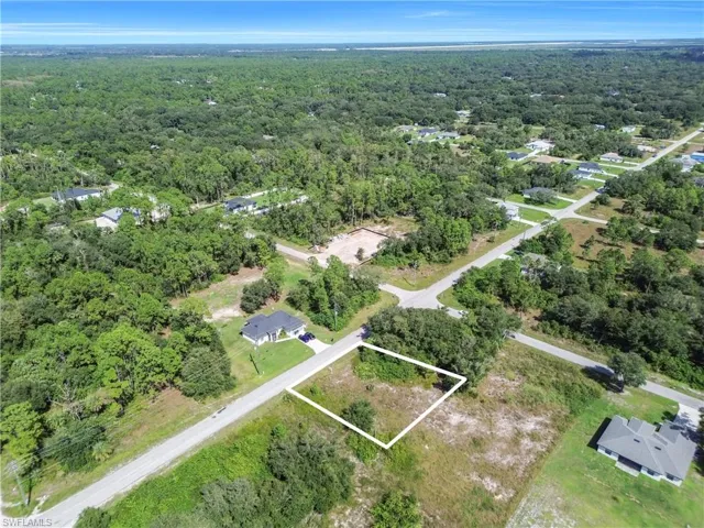 Aerial overview of property's location featuring a forest and property parcel outlined