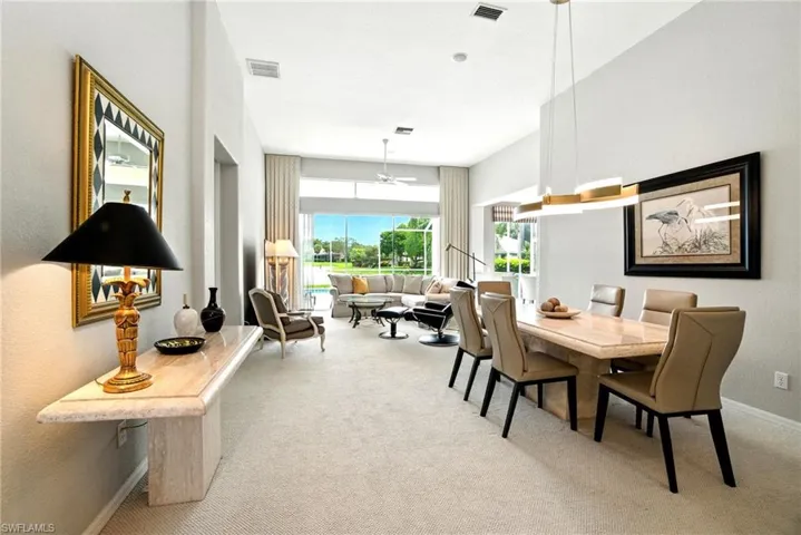 Dining room featuring ceiling fan and light colored carpet