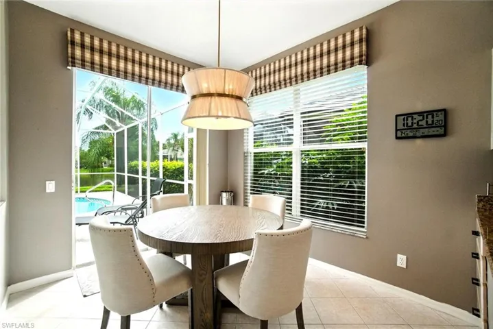 Dining room featuring light tile patterned floors and a sunroom