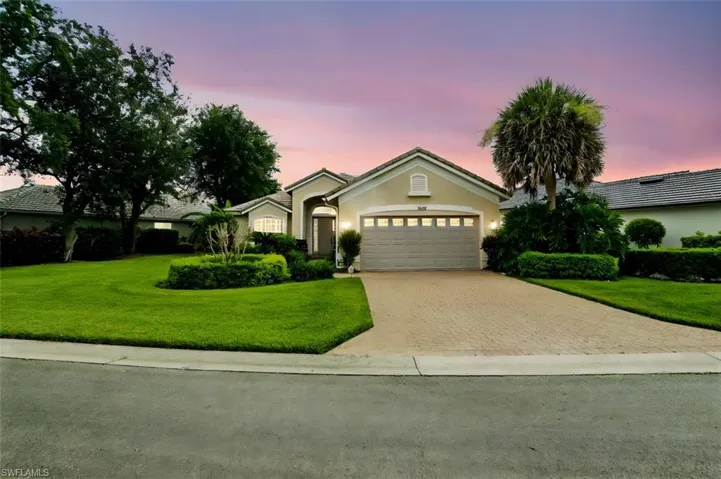 Single story home featuring decorative driveway, stucco siding, a garage, and a yard