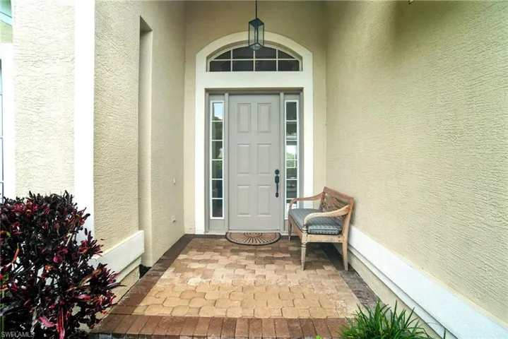 Doorway to property with stucco siding and a patio area