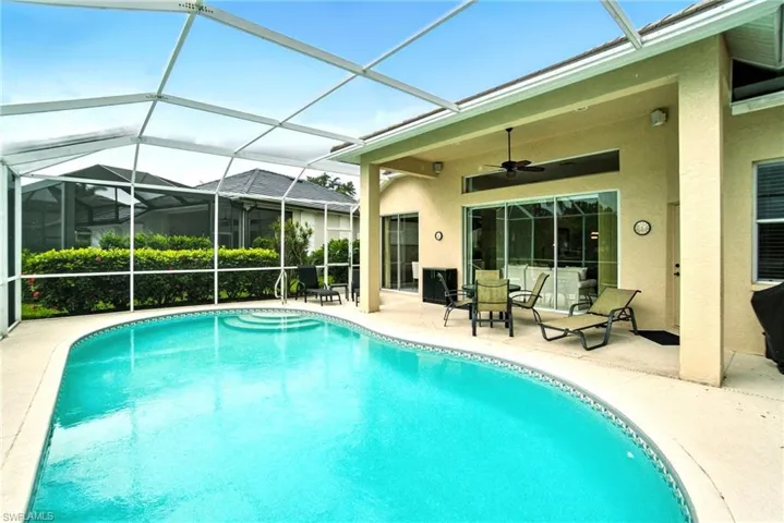 Outdoor pool with a lanai, a sunroom, and a patio
