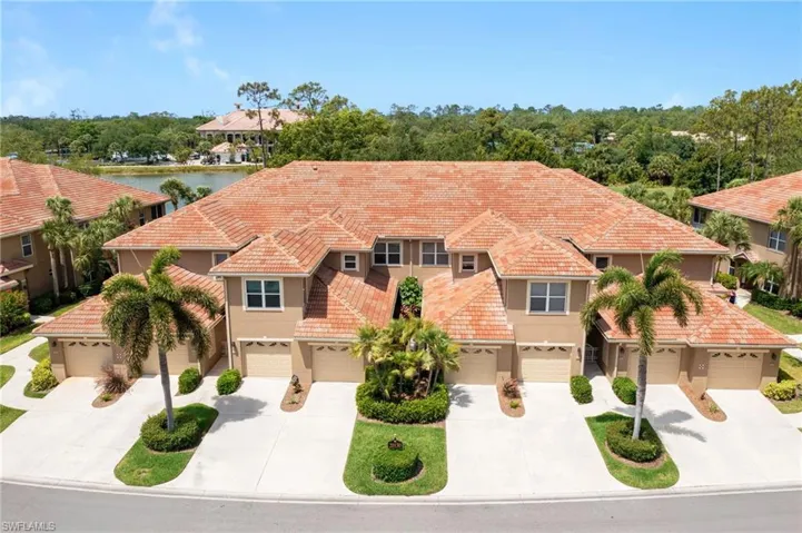 Mediterranean / spanish-style home featuring a tiled roof, a garage, stucco siding, and driveway