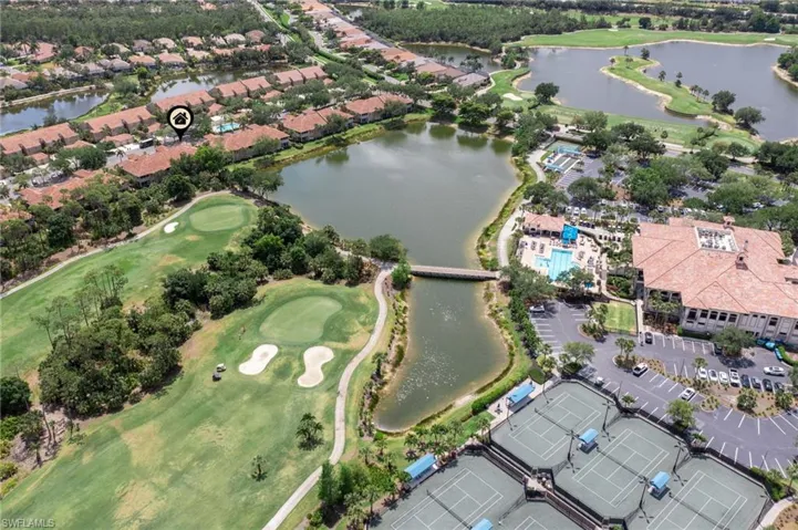 Aerial view featuring a water view and golf course view