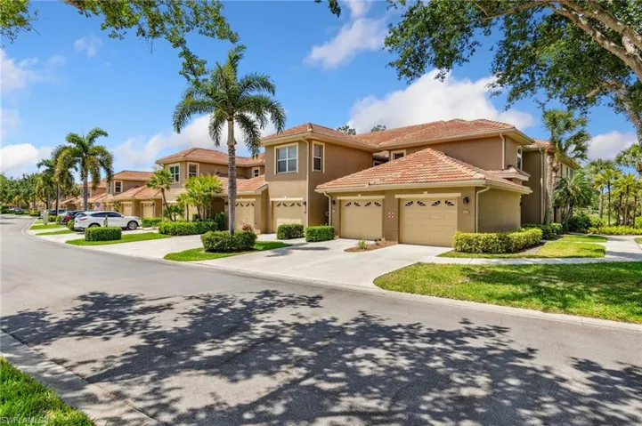 Mediterranean / spanish home with an attached garage, driveway, and stucco siding