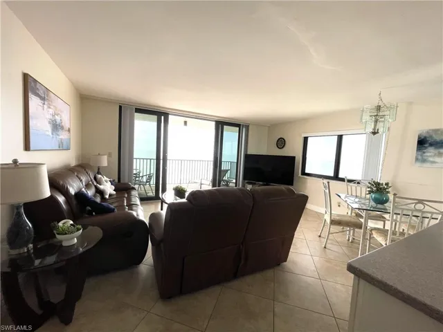 Living area featuring impact slider & impact side windows in this end unit-plenty of natural light