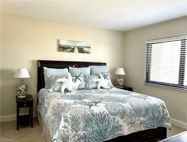 Primary bedroom w king size bed and walk-in closet-tile floor
