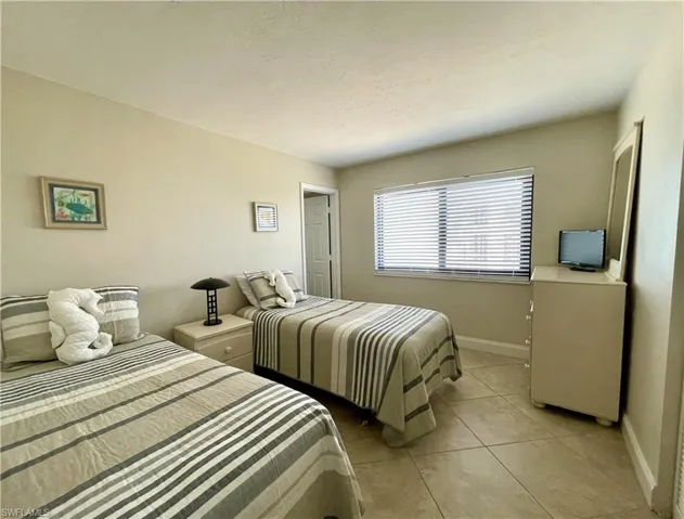 Guest Bedroom with private bath & walk-in closet with tile floor