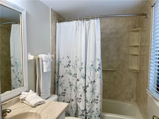 Guest Bathroom with vanity and shower / bath combination with curtain