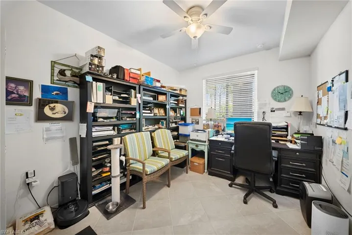 Home office featuring a ceiling fan and light tile patterned floors