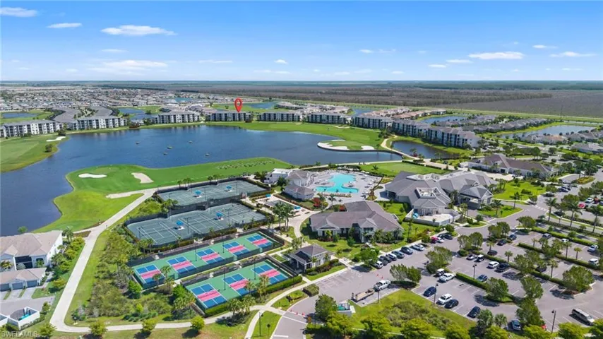 Aerial view of residential area with a golf course and a large body of water
