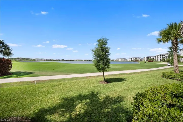 Surrounding community featuring golf course view and a water view