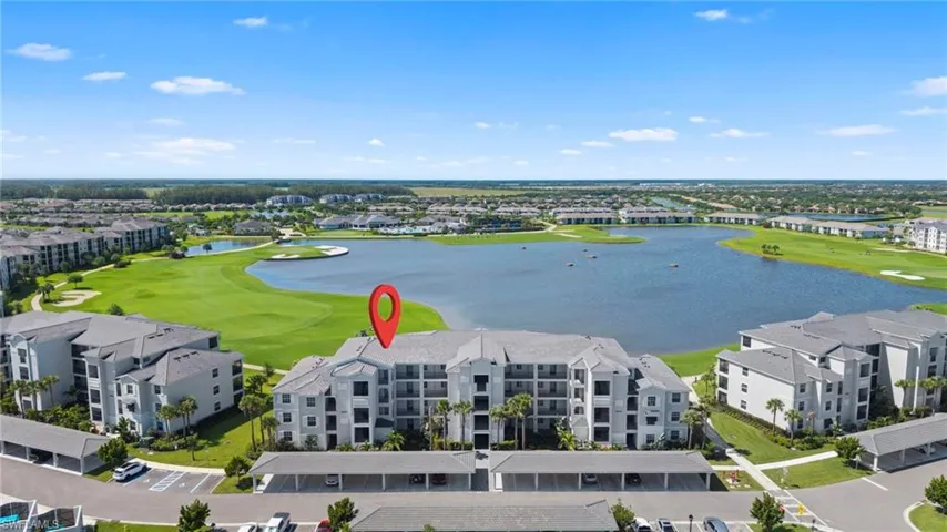 Drone / aerial view of a nearby body of water and a local golf course