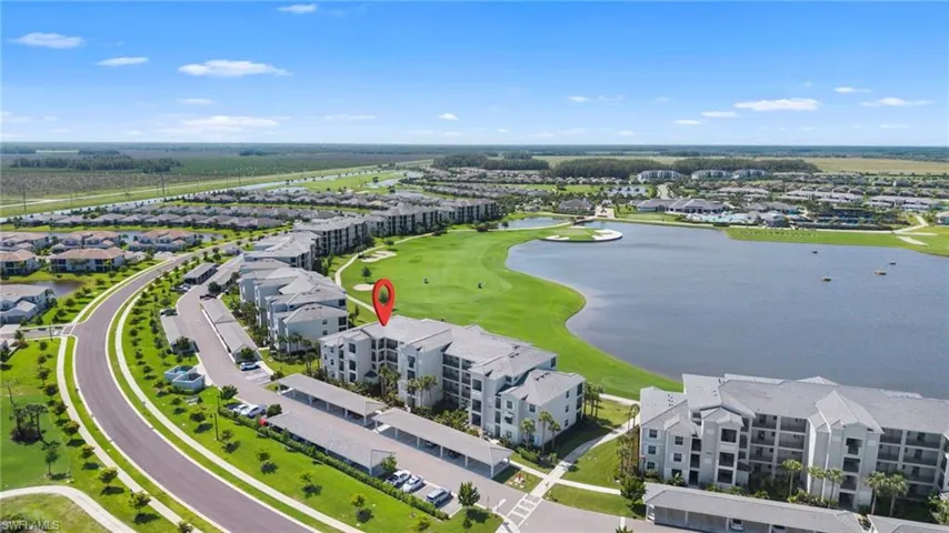 Aerial view of residential area with a large body of water and a golf course