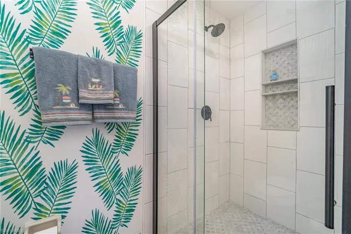 Full bathroom featuring a shower stall