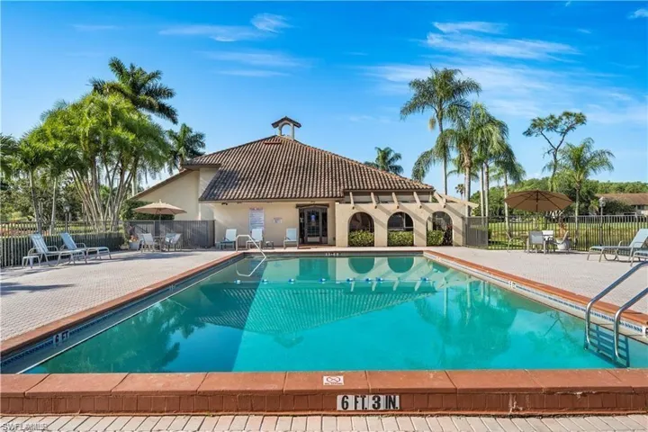 Community pool with a patio