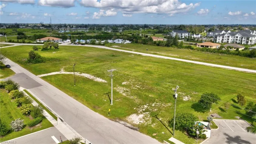 Aerial view of residential area featuring a nearby body of water