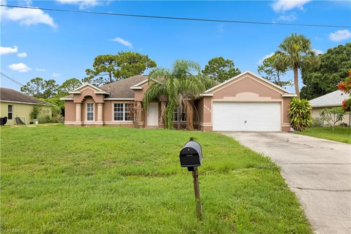 Single story home with a front lawn and a garage