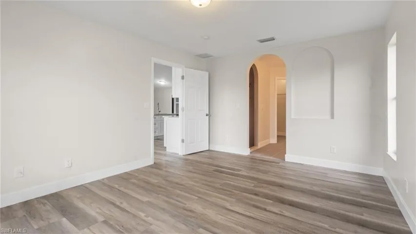 Empty room with light hardwood / wood-style floors