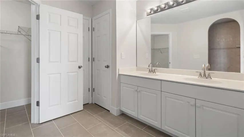 Bathroom featuring tile patterned flooring and vanity
