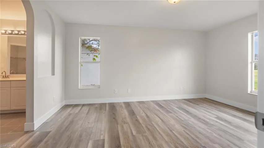 Empty room with a healthy amount of sunlight and light hardwood / wood-style flooring