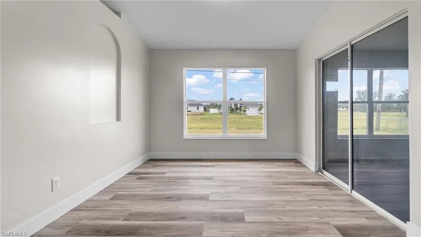 Empty room with light hardwood / wood-style flooring
