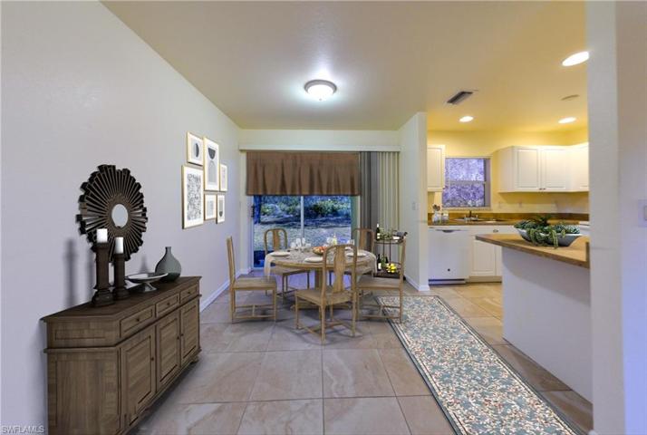 Dining area and partial view of kitchen ( virtually staged )