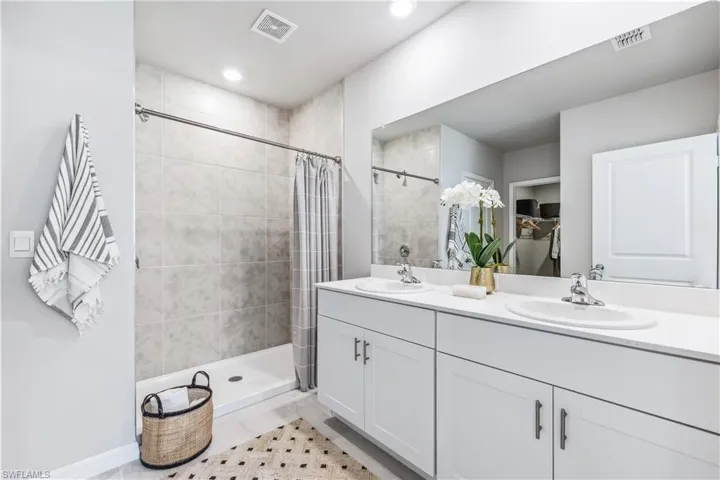 Bathroom featuring vanity and walk in shower