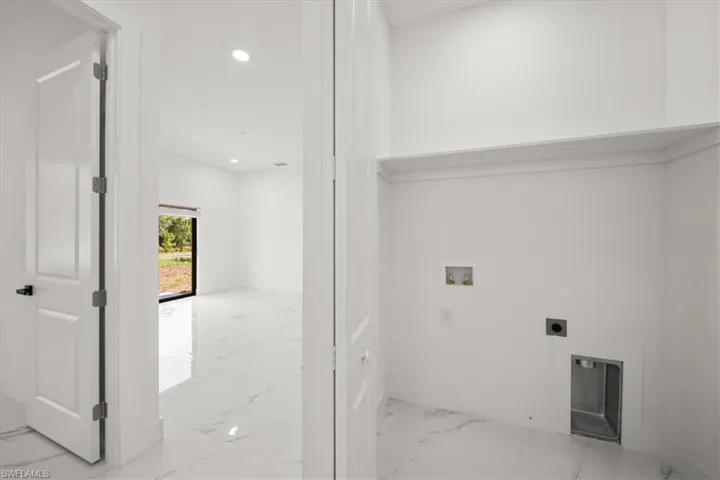 Washroom featuring washer hookup, electric dryer hookup, marble finish flooring, and recessed lighting