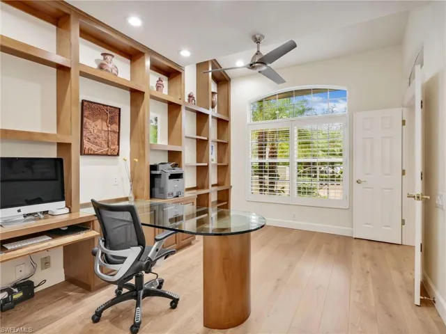 The office with custom built in desk and and shelving
