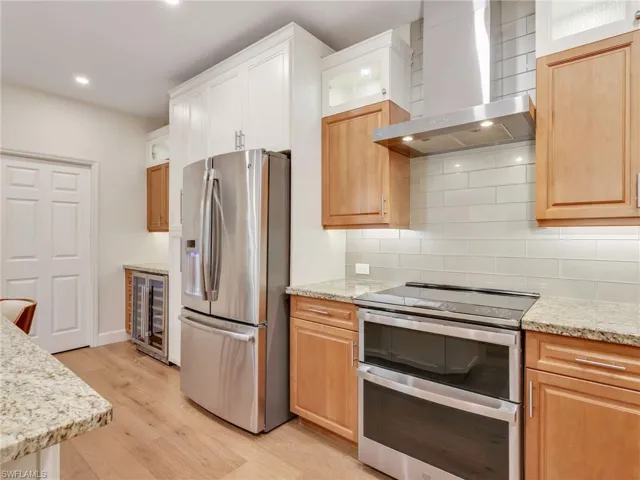 Built in double oven, hood, refrigerator and beverage cooler.