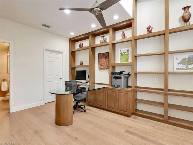 A custom office with walk in closet and access to the powder bath