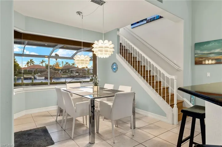 Dining space with a water view and light tile patterned flooring