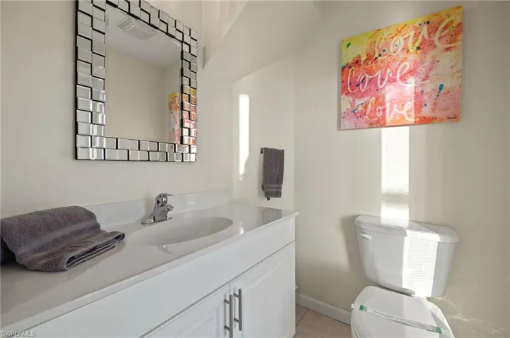 Bathroom with tile patterned floors, vanity, and toilet