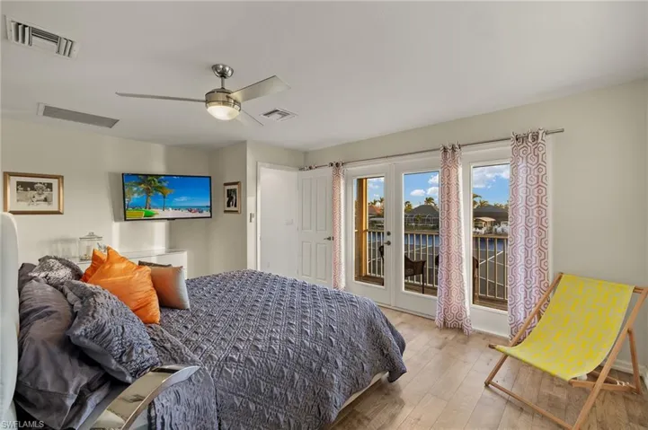 Bedroom with ceiling fan, access to exterior, and light wood-type flooring