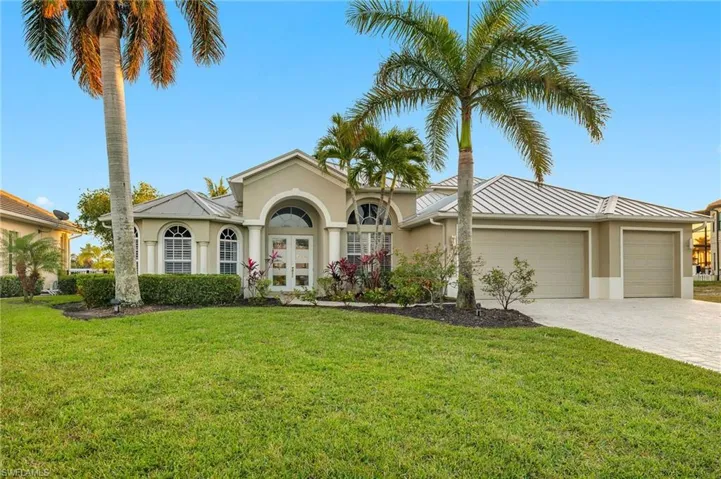 View of front of house with a garage and a front yard