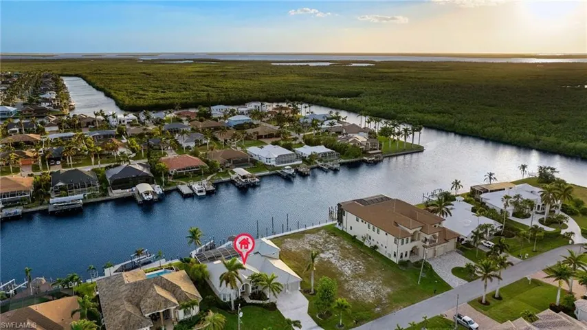 Aerial view at dusk featuring a water view
