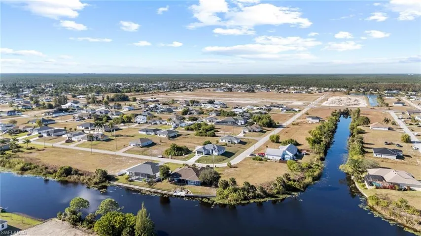Aerial perspective of suburban area featuring a nearby body of water