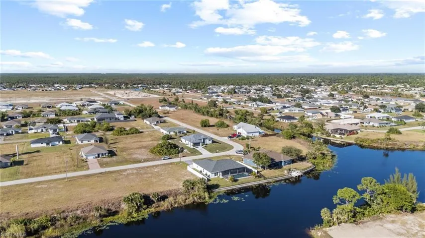 Aerial view of residential area featuring a large body of water