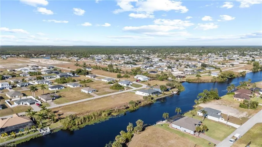 Aerial view of residential area featuring a nearby body of water