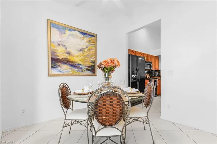 Dining area featuring light tile patterned floors and baseboards